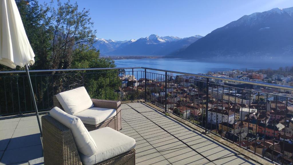 a balcony with chairs and a view of a city at Bell orizzonte in Locarno