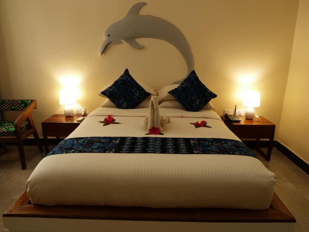 Postel nebo postele na pokoji v ubytování Double A Nungwi Beach Hotel