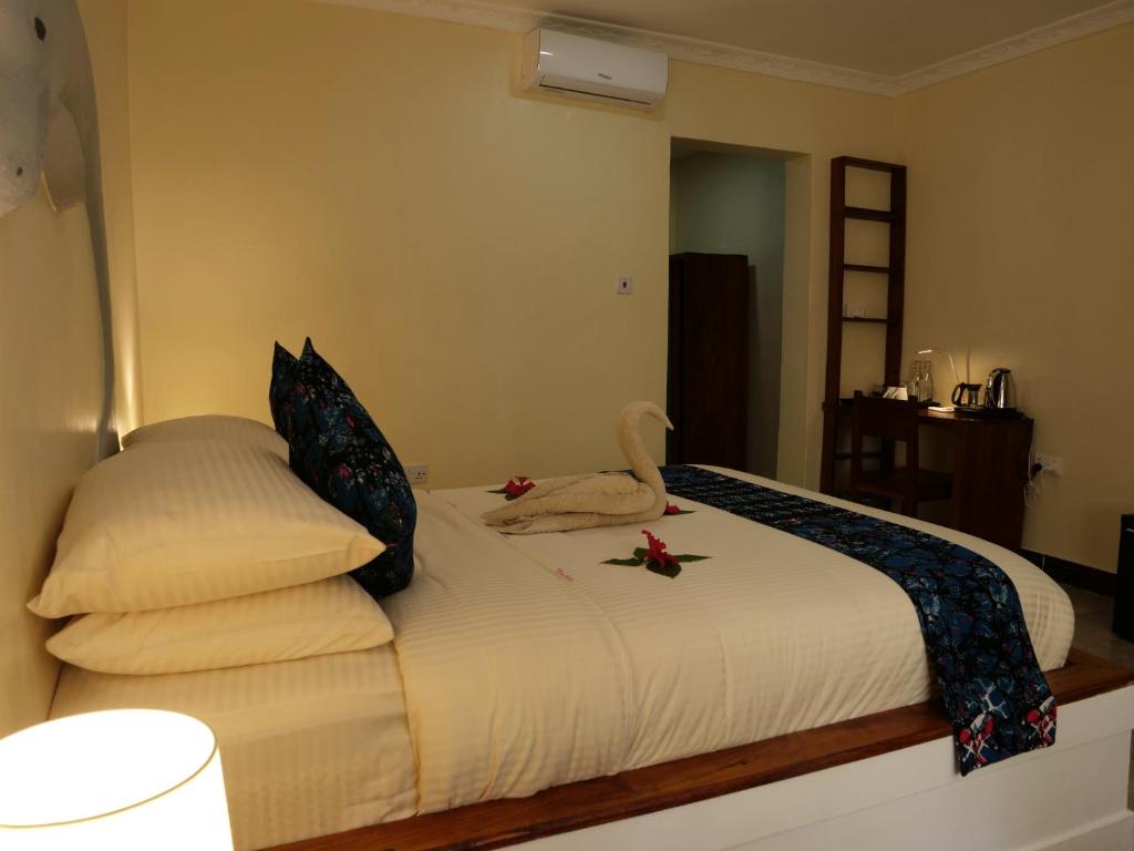 Postel nebo postele na pokoji v ubytování Double A Nungwi Beach Hotel