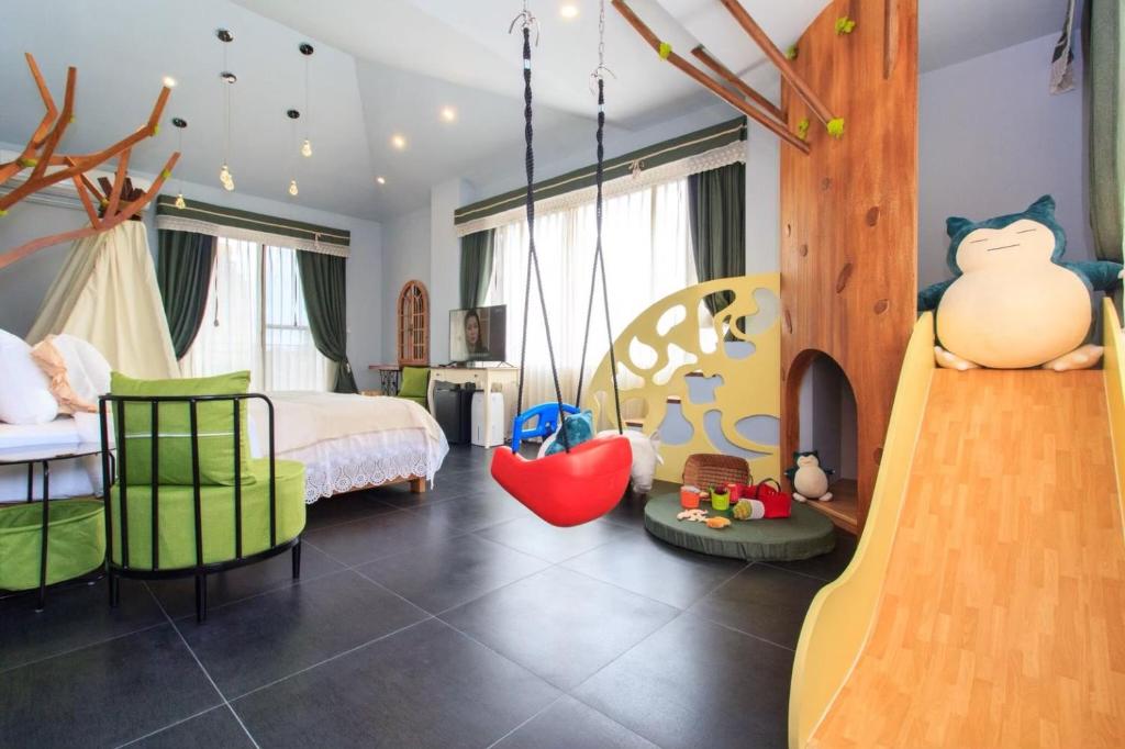 a room with a bedroom with a bed and a swing at Elegance House in Wujie