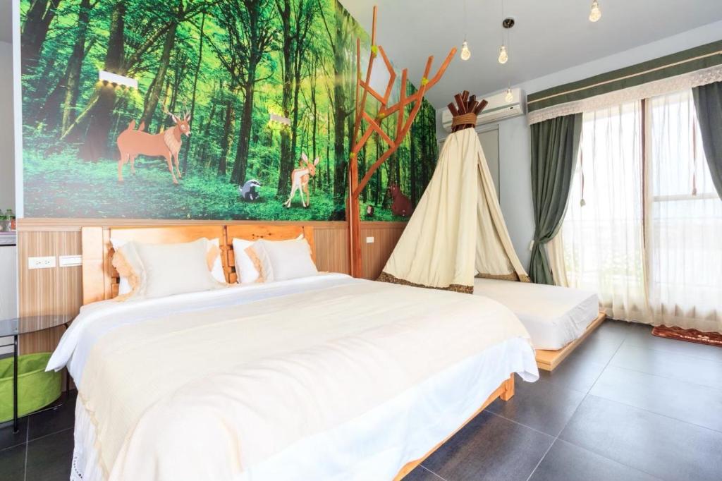 a bedroom with two beds and a painting on the wall at Elegance House in Wujie