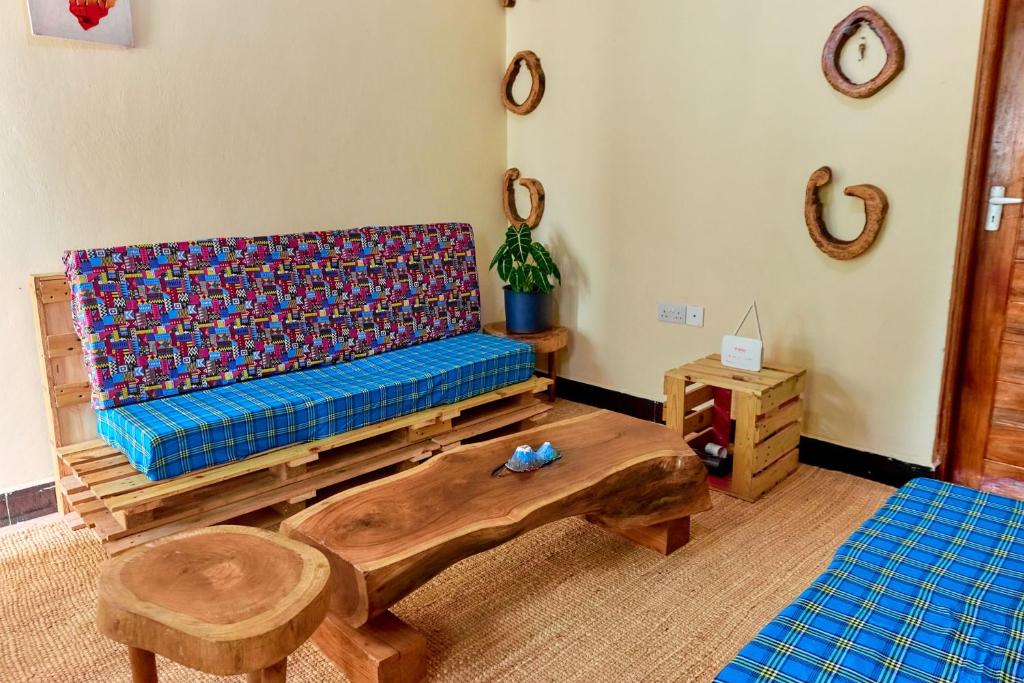 a living room with a couch and a table at Maasai House - Arusha in Sokon