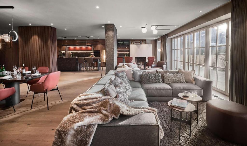 a living room with a couch and a table at Grand Tirolia Kitzbühel - Member of Hommage Luxury Hotels Collection in Kitzbühel