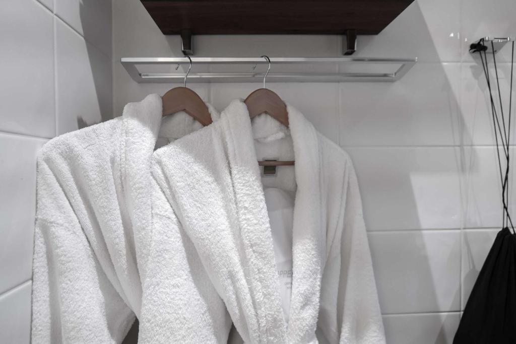 a bathroom with white towels on a rack at Best Western Plus Park City Solna in Solna