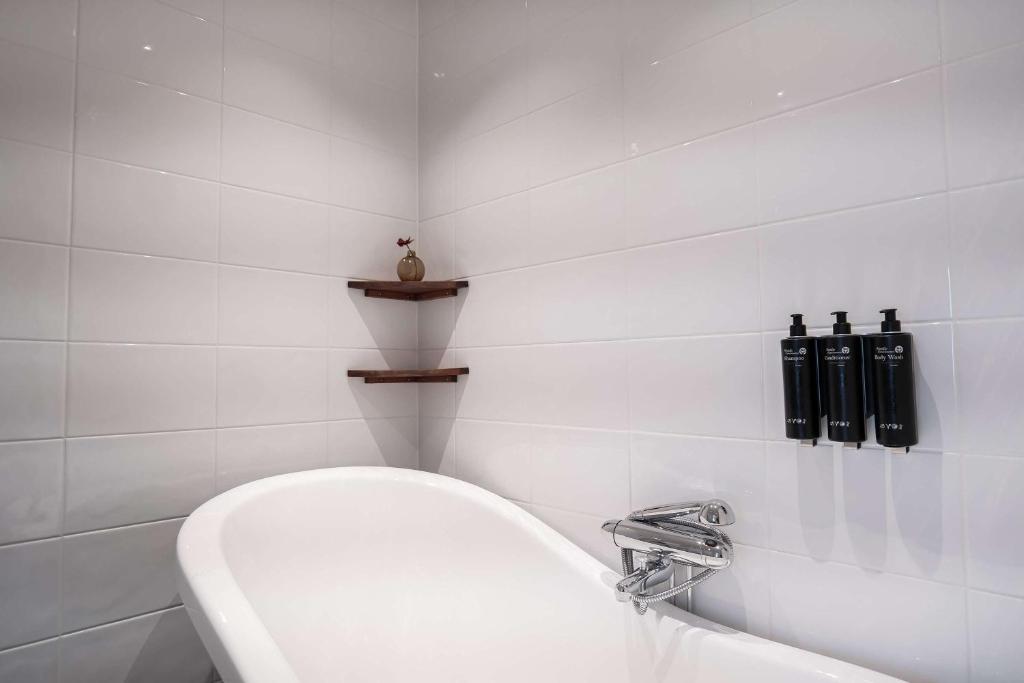 a white bathroom with a toilet and a sink at Best Western Plus Park City Solna in Solna