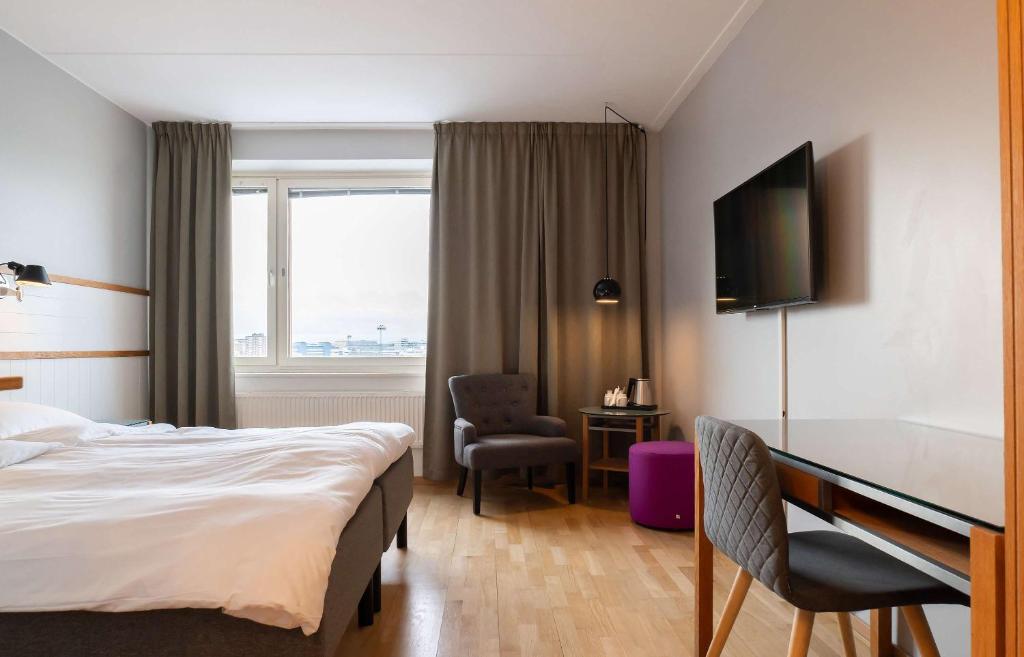 a hotel room with a bed and a desk at Best Western Plus Park City Solna in Solna