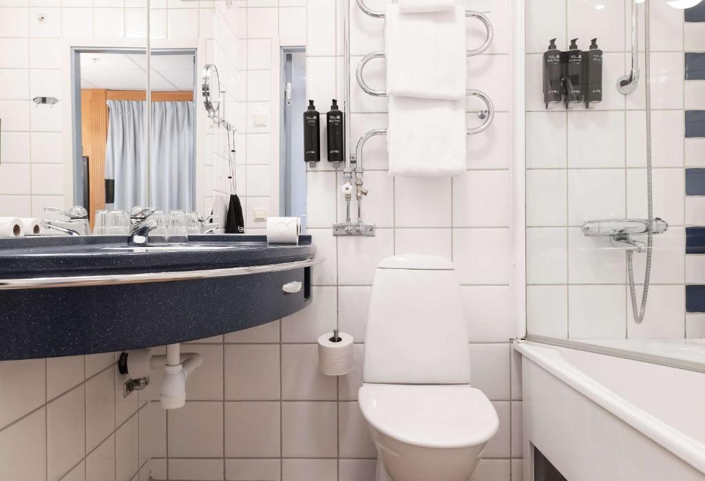 a white bathroom with a toilet and a sink at Best Western Plus Park City Solna in Solna