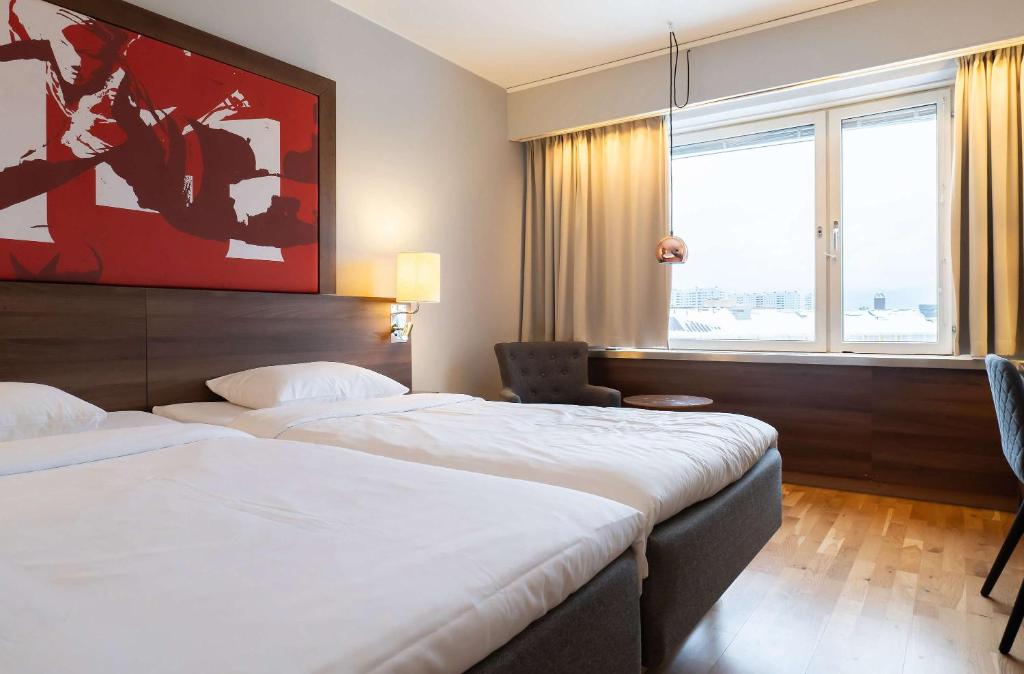 a hotel room with two beds and a window at Best Western Plus Park City Solna in Solna