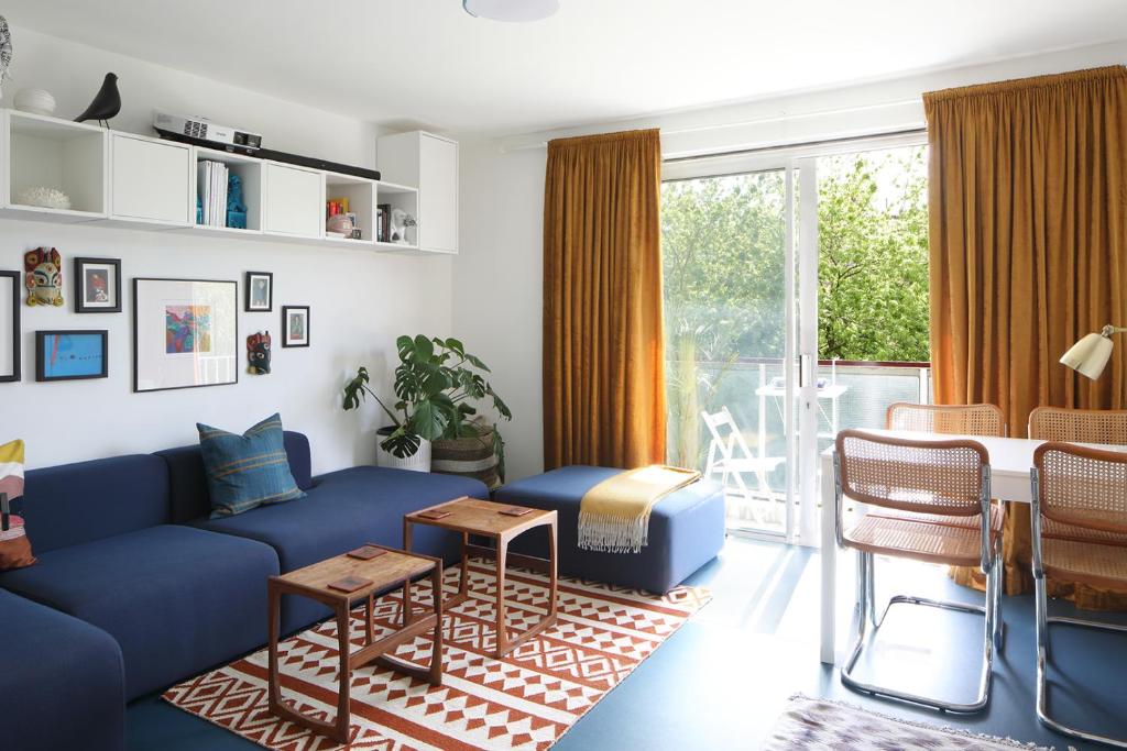 a living room with a blue couch and a table at Modern Apartment on London's Southbank in London