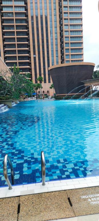 a large swimming pool in a city with tall buildings at BBS APARTMENT AT TIMES SQUARE KUALA LUMPUR MALAYSIA in Kuala Lumpur