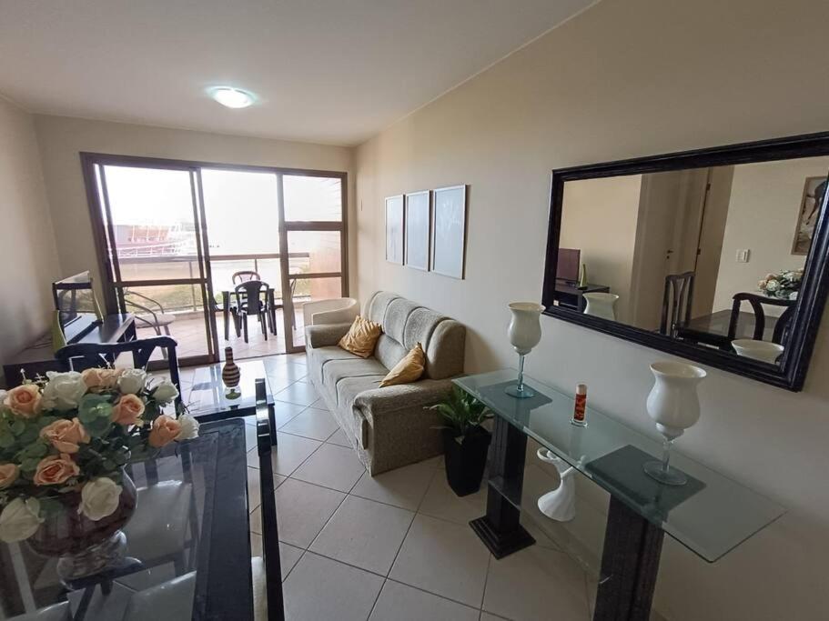 a living room with a couch and a table at Apartamento Barra Villa d Italia HIR 32 in Rio de Janeiro