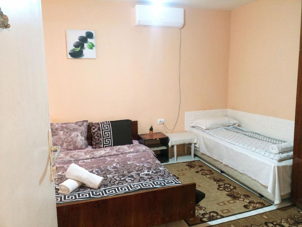 a living room with a bed and a couch at Guest House Emiliya in Ovchartsi