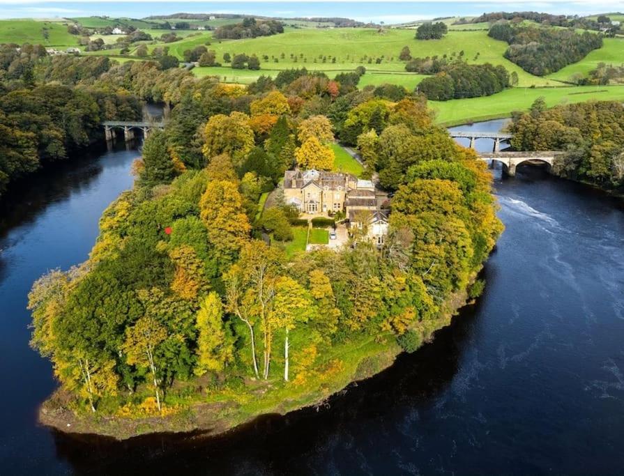 una casa en una isla en medio de un río en 6* Royal Garden Suite Private Island Lake District, en Caton