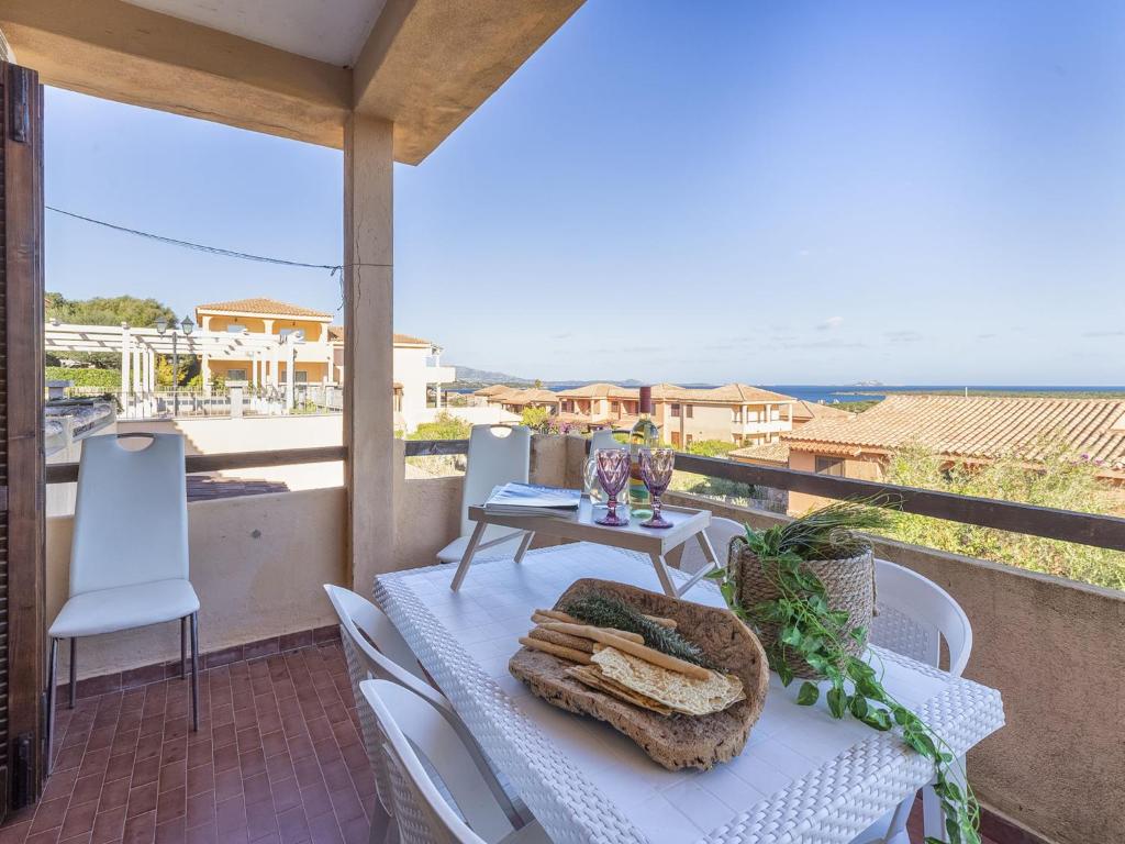 a table and chairs on a balcony with a view of the ocean at Apartment CSB-13 by Interhome in Santa Marinella