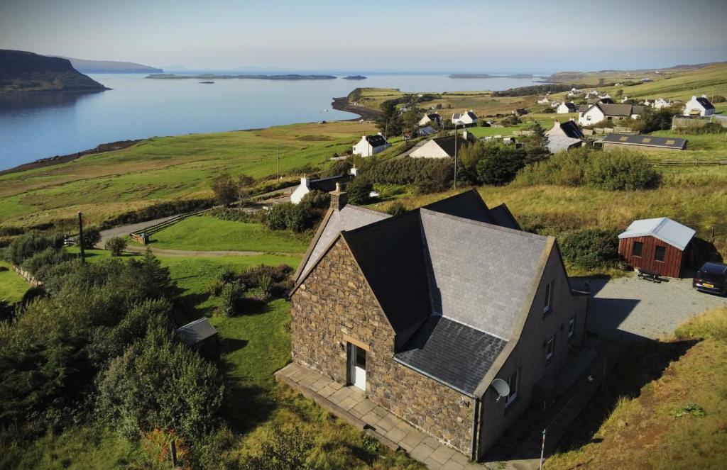 an aerial view of a stone house on a hill with a body of water at La Bergerie in Stein