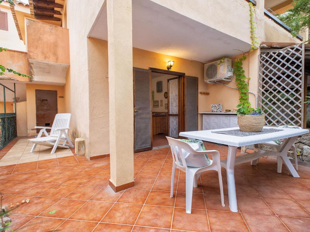 a patio with a white table and chairs at Apartment D4 - A2 by Interhome in Santa Marinella