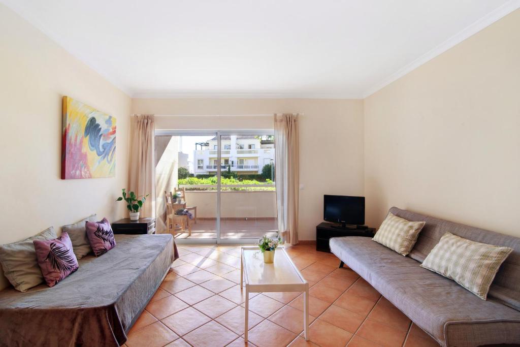 a living room with a couch and a tv at Apartamento T3 Santa Luzia - H in Santa Luzia