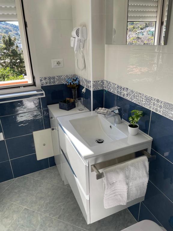 a bathroom with a white sink and a mirror at Casa Maria Grazia Camera vista mare in Anacapri