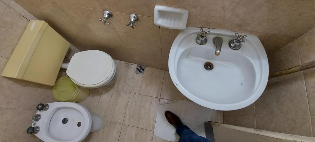 a bathroom with a sink and a toilet at Centrico Hotel BA in Buenos Aires
