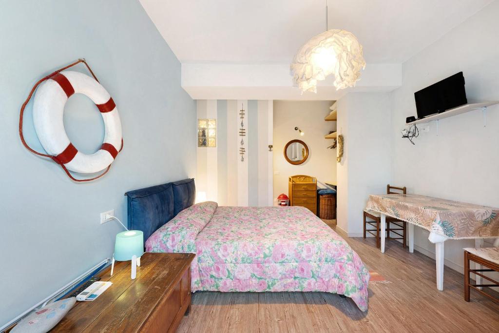 a bedroom with a bed and a beach ball on the wall at Goccia di mare with free parking in Levanto