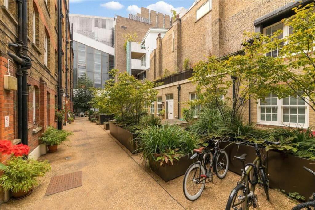 two bikes parked on a sidewalk next to buildings at One-bed flat Payment required STRAIGHT away the host will message you after you've made a reservation in London