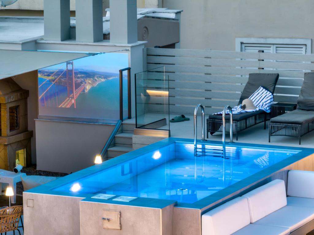 a pool in a building with a view of a bridge at El Cielo Where Luxury meets the sky in Kalamata