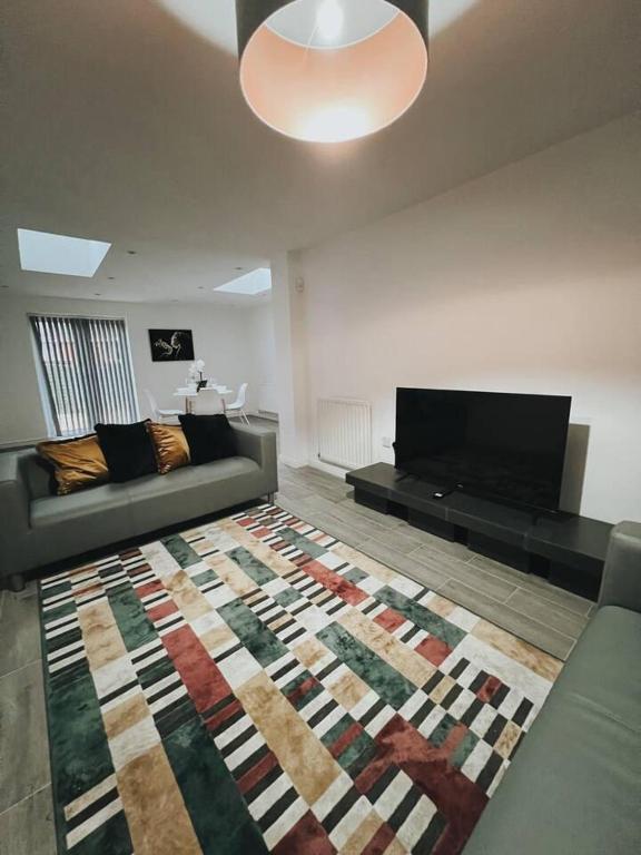 a living room with a couch and a rug at Stunning 3-Bed House in Oldbury in Birmingham