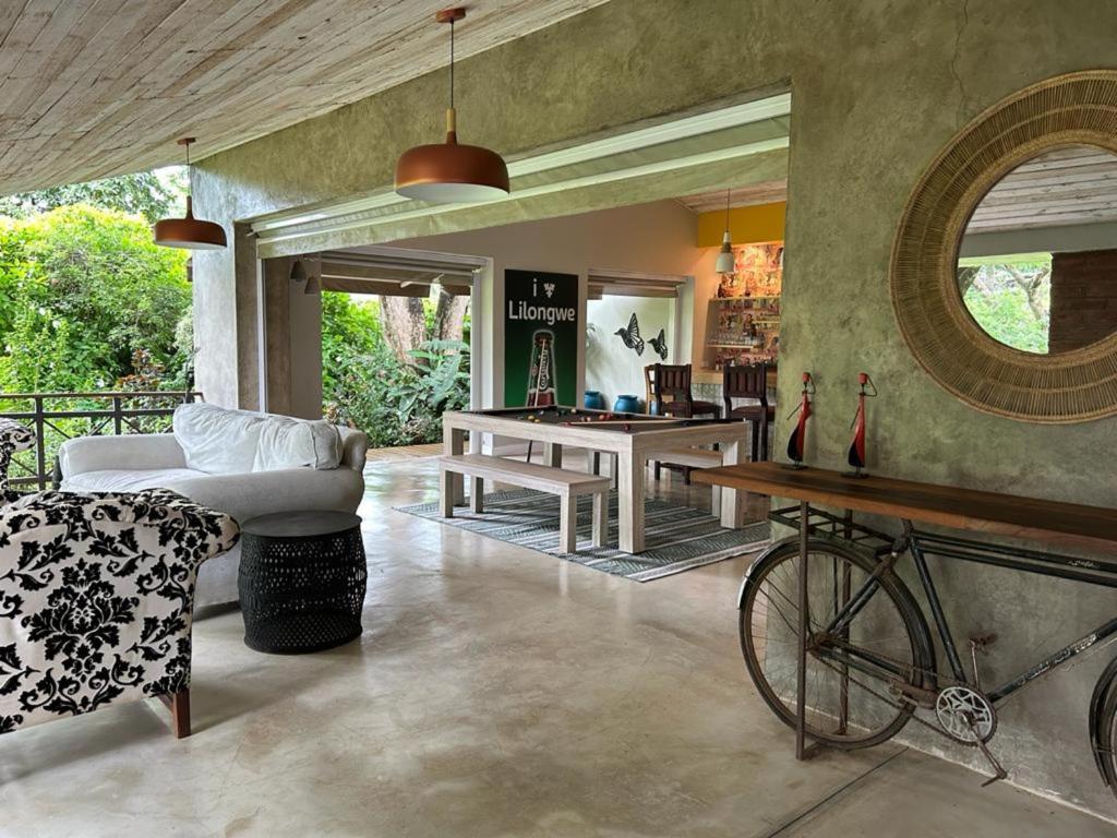 a living room with a pool table and a bicycle at Green Elephant in Lilongwe