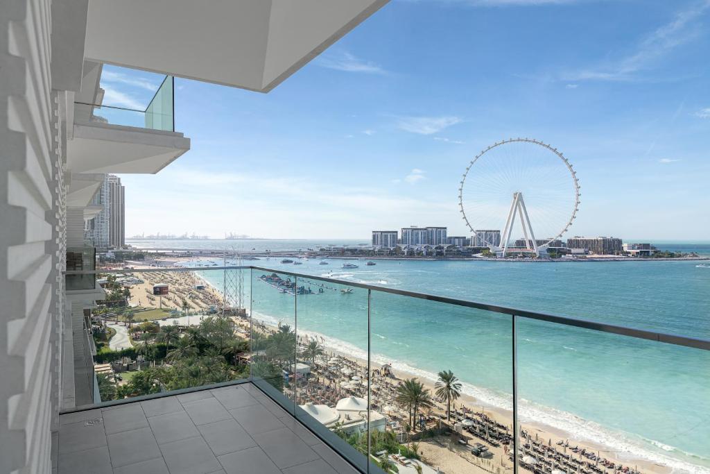 a balcony with a view of the beach and the coast at 3Bed Private Beach - Belle vie à La Vie Dubai in Dubai