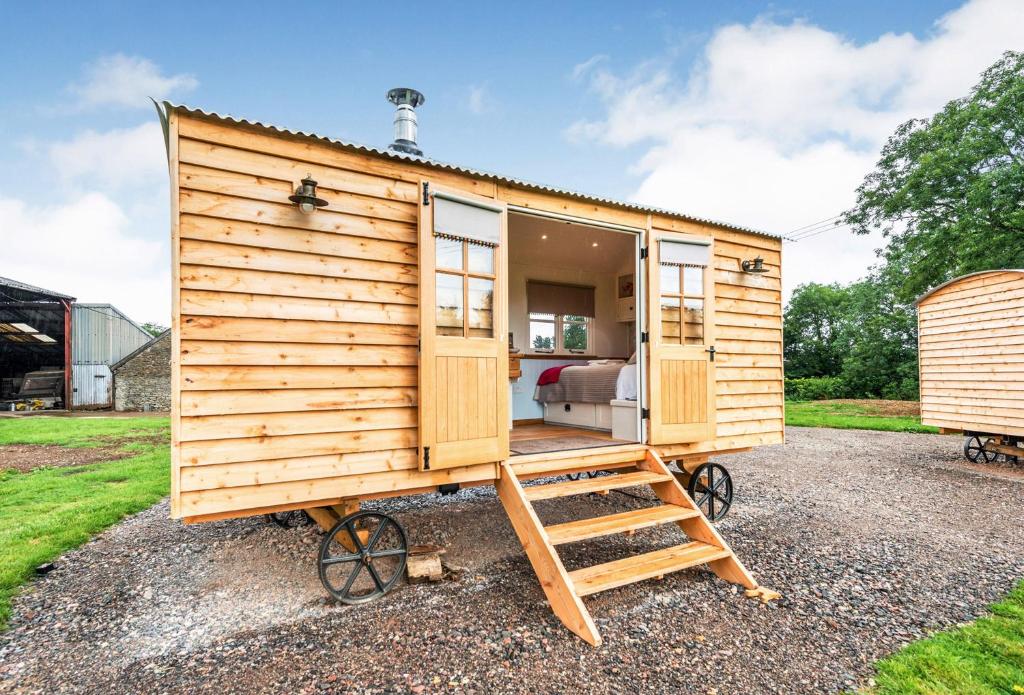 a wooden tiny house on wheels with a ladder at Apple in Sherborne