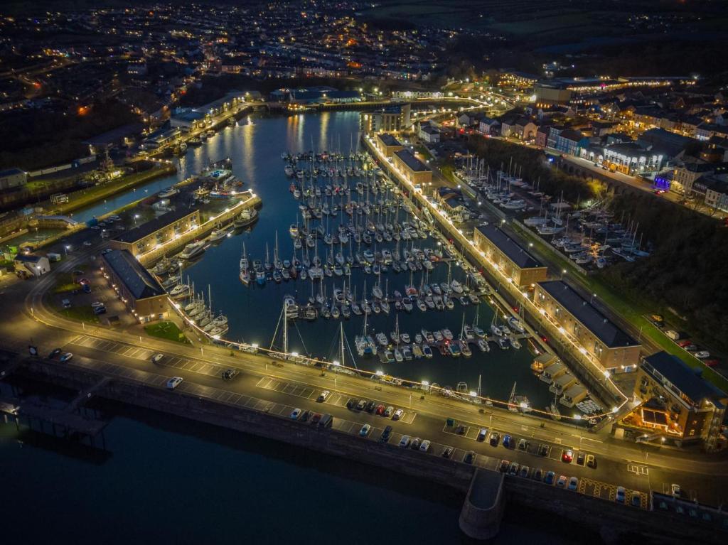 an aerial view of a marina at night at Fulke Street - 2 Bedroom Apartment - Milford Haven in Milford Haven