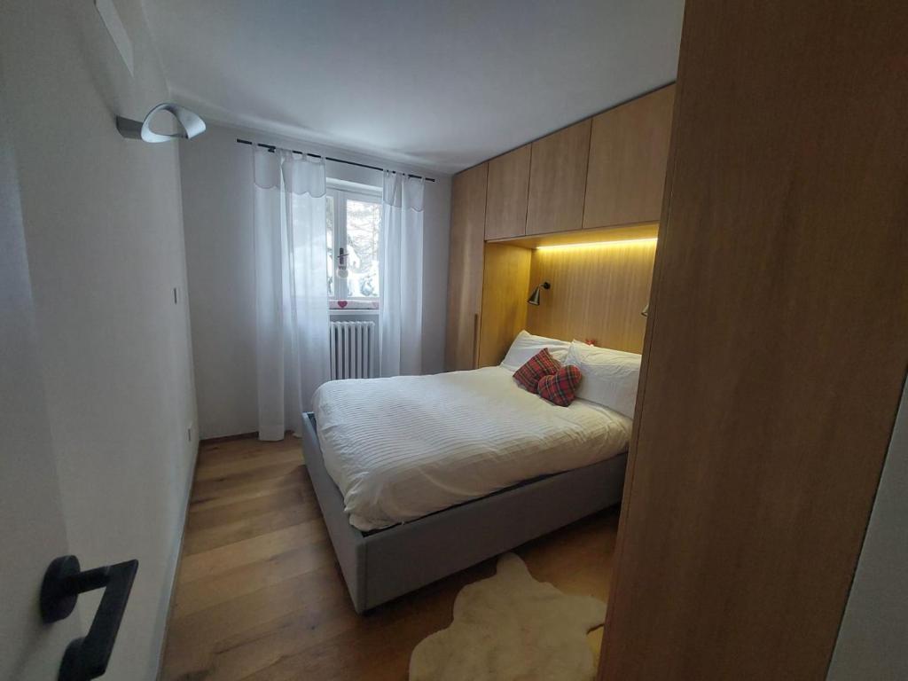 a small bedroom with a bed and a window at Sauze Apartment in Sauze dʼOulx