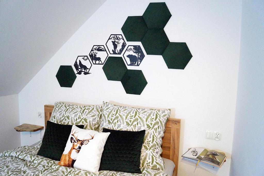 a bedroom with a bed with green recycle wall decals at Dom Gościnny Przy Szlaku Jeleni in Ustroń