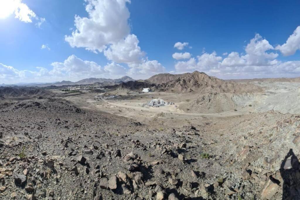 an aerial view of a desert with rocks and mountains at Masfout/hatta mountain villa in Sinādil