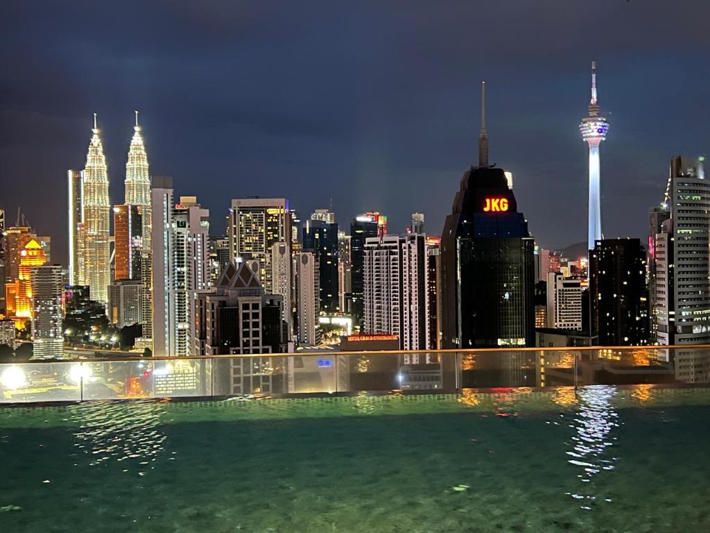a view of a city skyline at night at Regalia Spritz Empire Hostel in Kuala Lumpur