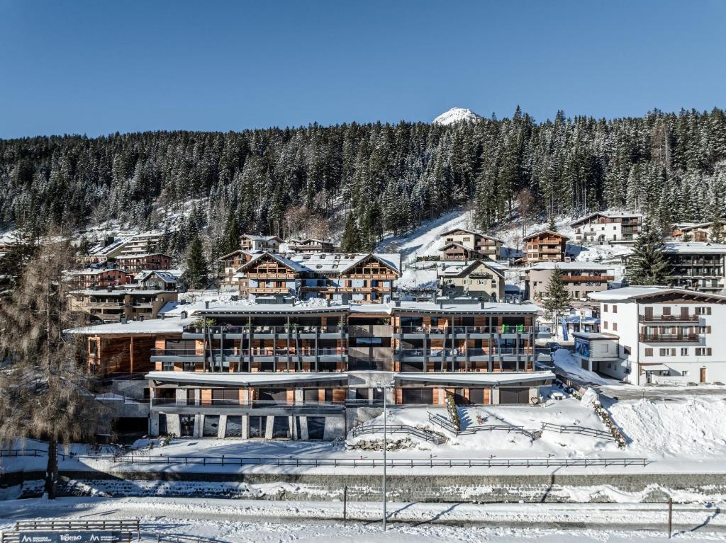 a large building in the middle of a snow covered mountain at Campiglio WOOD in Madonna di Campiglio