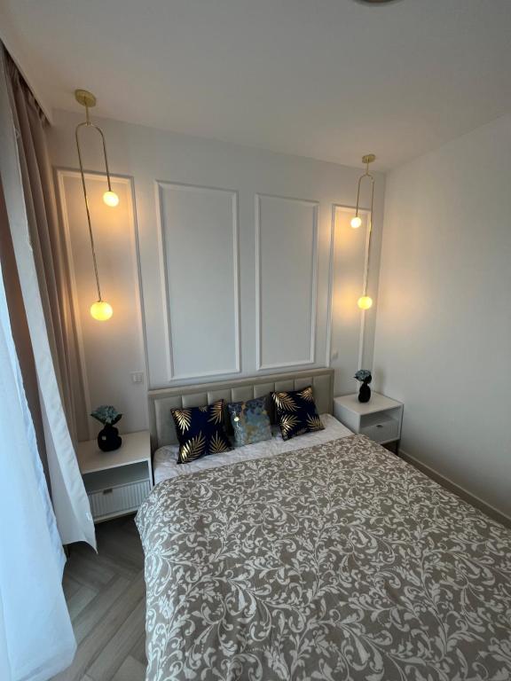 um quarto com uma cama grande e 2 mesas de cabeceira em Apartament Vulcano Komfort Nowy Ursus em Varsóvia
