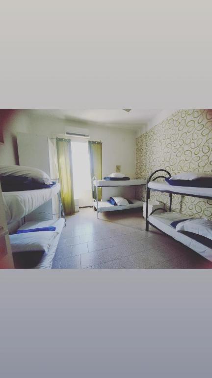 a room with two bunk beds and a hallway at Hostel Castello Maggiore in Rome