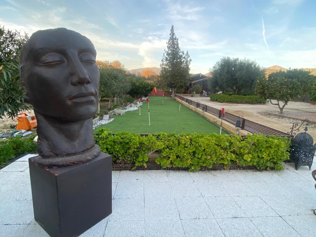 a statue of a head in a park at FINCA ALMAZARA in San Pablo