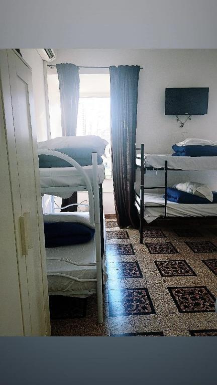 a room with two bunk beds and a window at Hostel Castello Maggiore in Rome