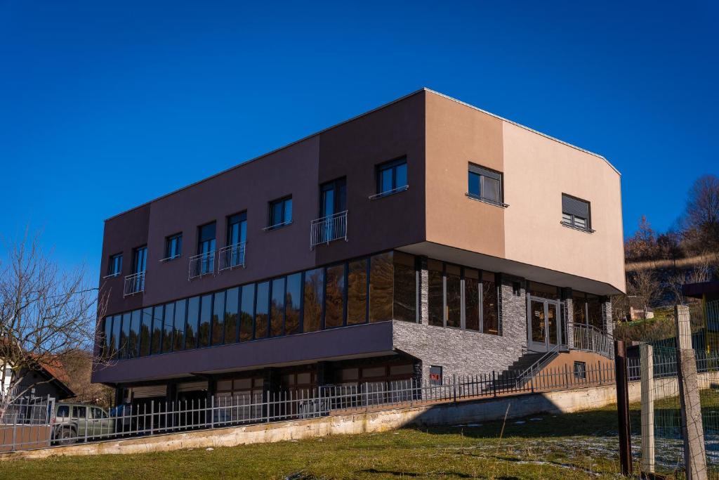 a large building with windows on the side of it at Ema, Asja, Eda Apartments in Zenica
