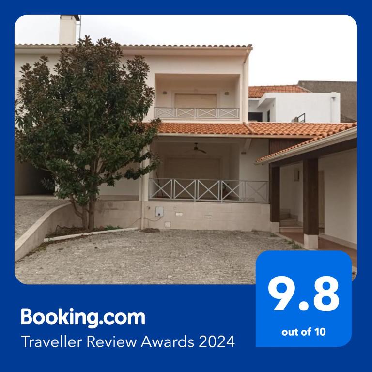 a house with a tree in front of it at GEMA Village in Coimbra