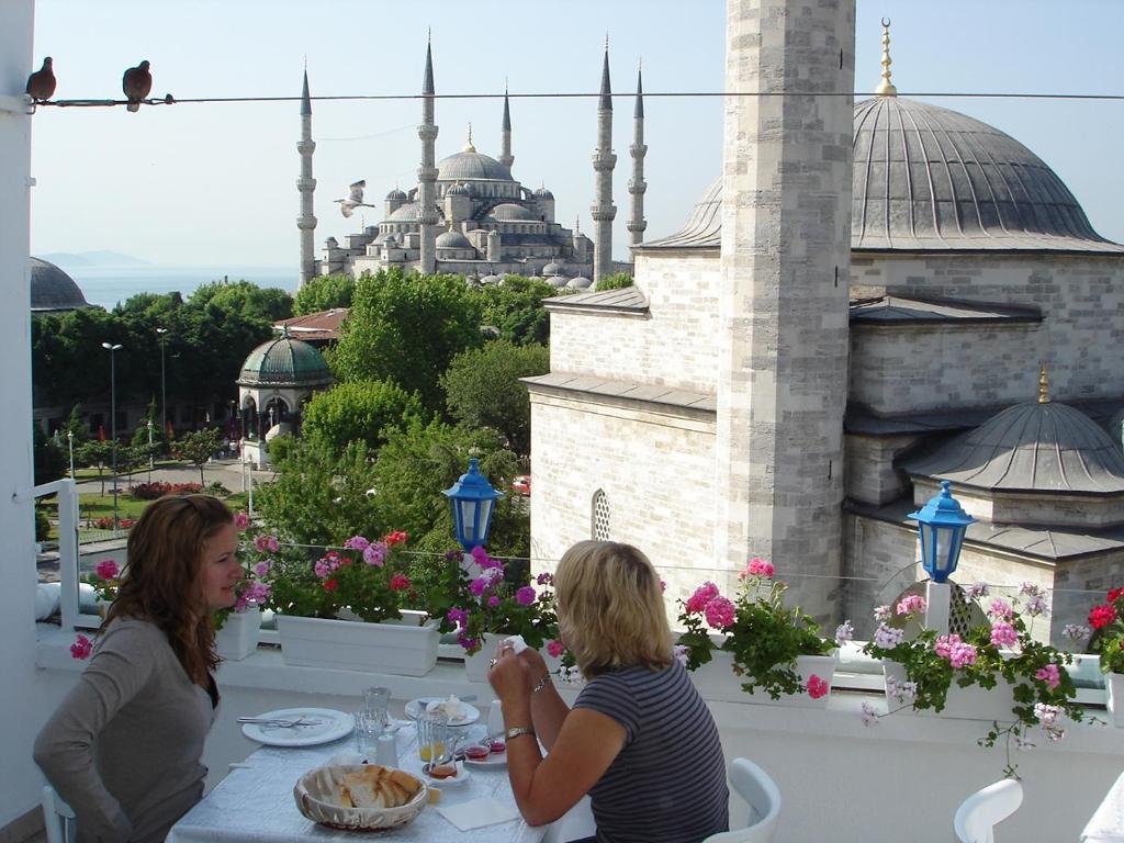 two women sitting at a table with a view of a mosque at No20 Hotel Sultanahmet in Istanbul