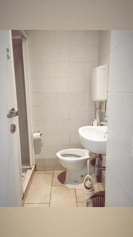 a bathroom with a toilet and a sink at Hostel Castello Maggiore in Rome