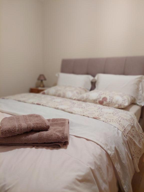 a bedroom with two beds with towels on them at Maria's House in Thessaloniki
