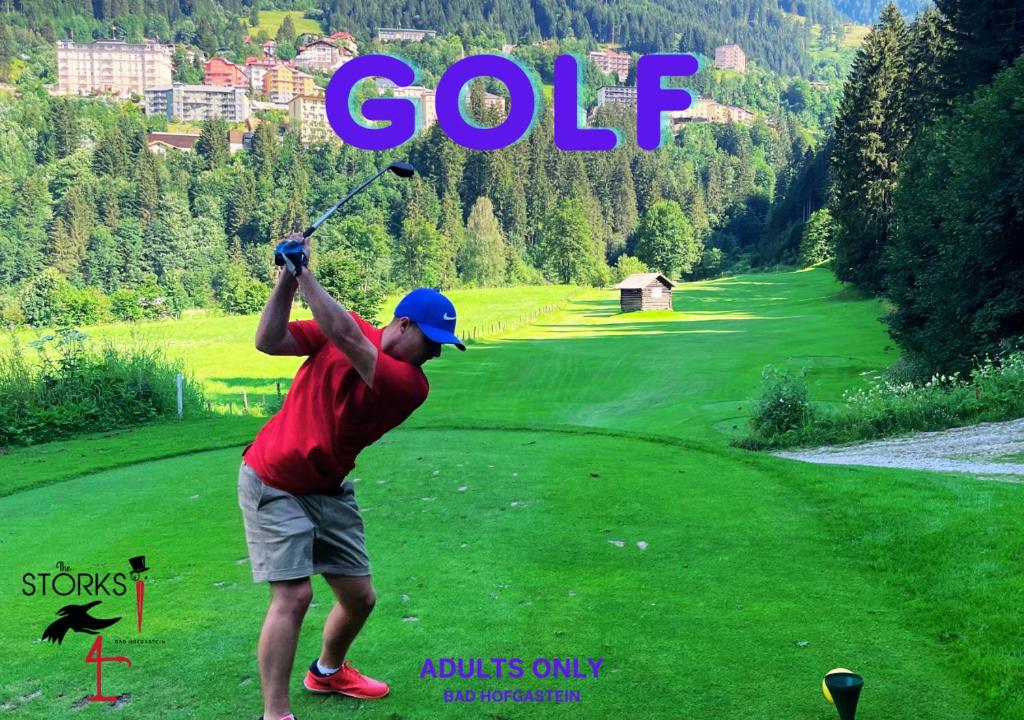 a man swinging a golf club on a golf course at Hotel Bad Hofgastein - The STORKS - Adults Only in Bad Hofgastein