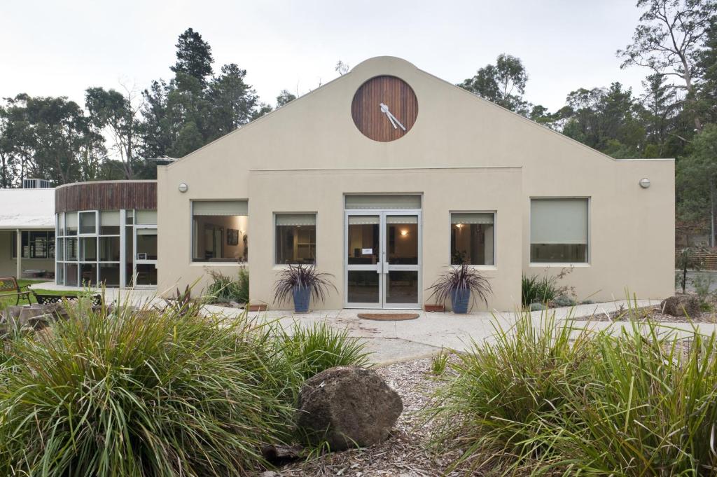 a large white building with a clock on it at Foothills in Lilydale