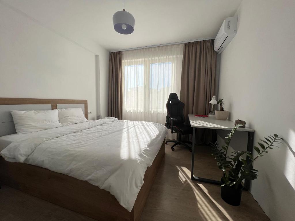 Schlafzimmer mit einem Bett, einem Schreibtisch und einem Fenster in der Unterkunft Cherry Apartment in Durrës