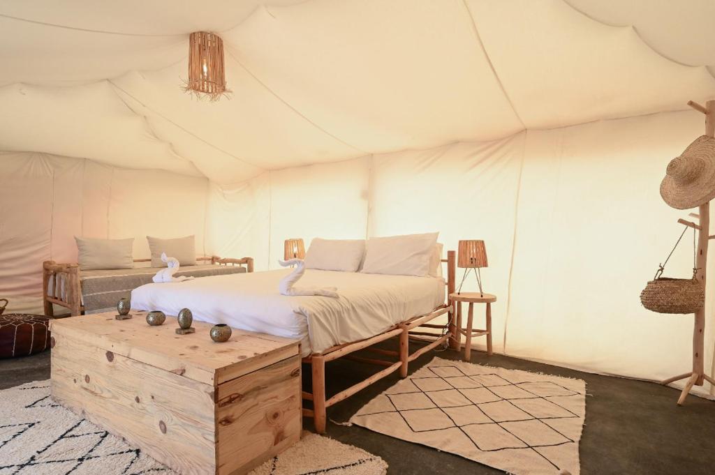 a bedroom with a bed in a tent at Emeraude Camp Agafay in El Karia