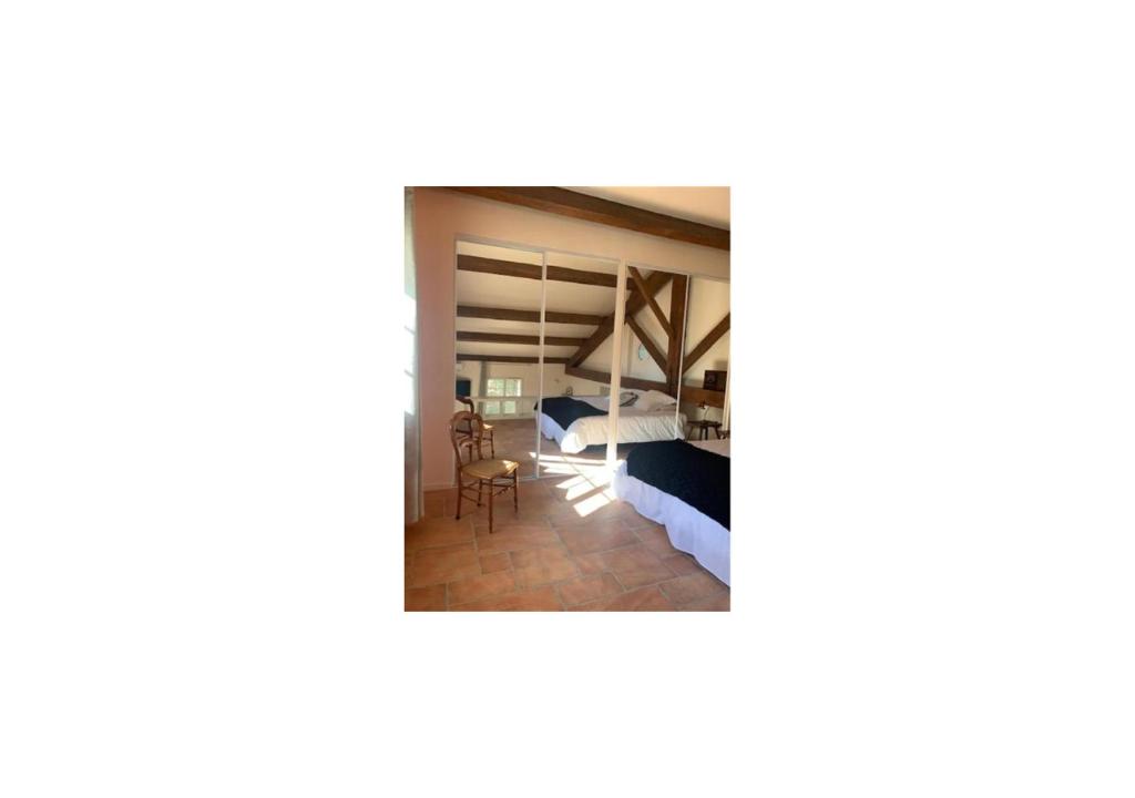 a view of a room with a bed and a desk at Chambres d&#39;hôtes la Soulenque Luxury B &amp; B in Capestang
